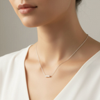 Model wearing a white top and a sterling silver delicate necklace made in Nottingham