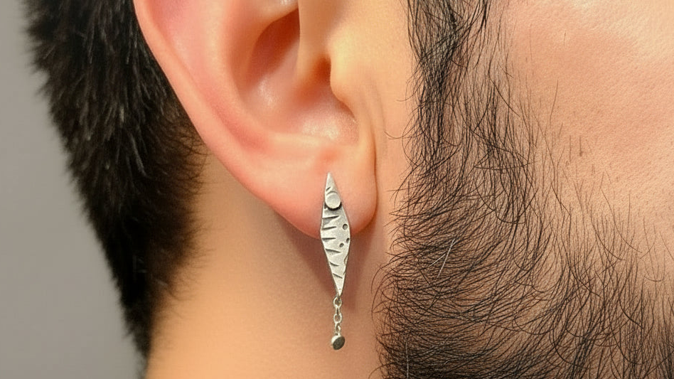 Man with beard wearing a handmade sterling silver single earrting for a man or boy made in Nottingham by Bottlebee makes sustainable bespoke jewellery