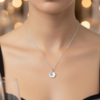 Woman wearing a sustainable bespoke sterling silver necklace hand stamped with the letter B, made by Bottlebee who is a small business jewellery maker in Nottingham