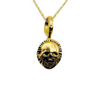 Handmade sustainable solid gold skull pendant on a chain against a white background