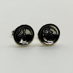 Pair of silver earrings with a skull emblem on a white background handmade by a small business called Bottlebee who makes sustainable jewellery in Nottingham