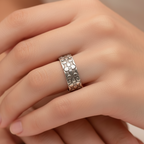 Woman wearing a unique wedding ring with a patterns that has been made sustainably by Bottlebee in Nottingham