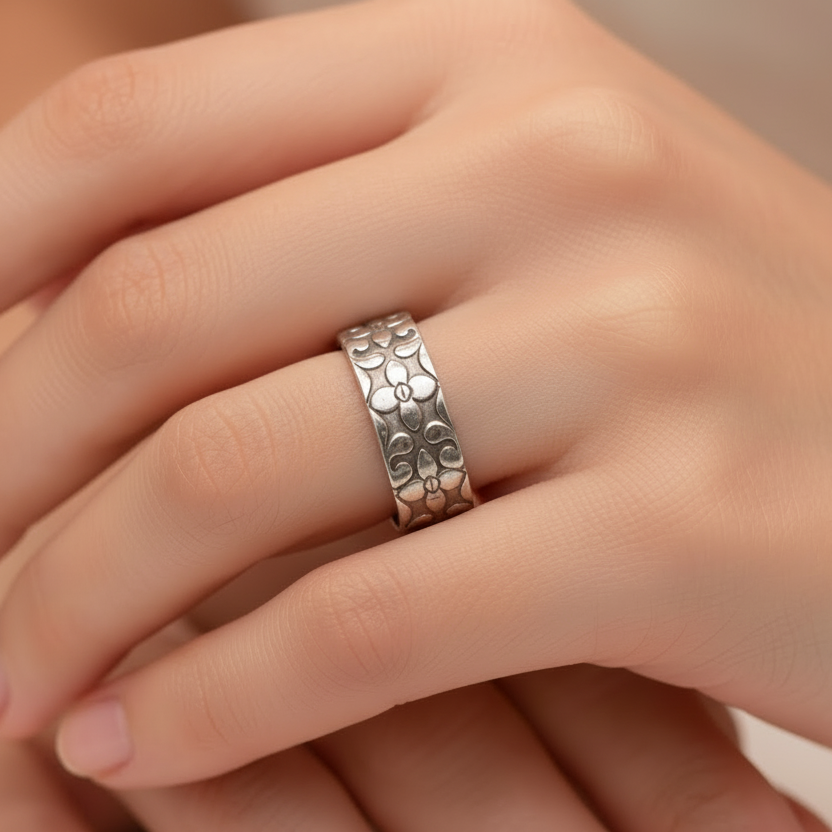 Woman wearing a unique wedding ring with a patterns that has been made sustainably by Bottlebee in Nottingham