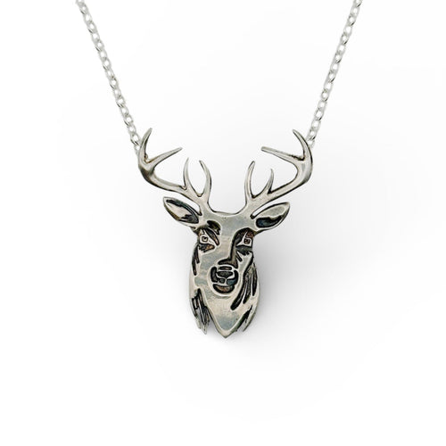 Silver deer face or stag face necklace on a white background handmade by Bottlebee in Nottingham who makes sustainable jewellery in silver and gold