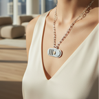 Woman wearing a handmade silver gold necklace with a paperclip chain and city scape in the background