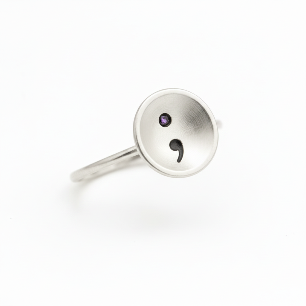 Solid sterling silver ring with a semi colon design on a white background, handmade jewellery Nottingham