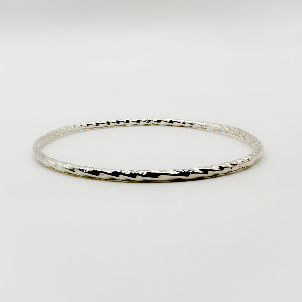 Sterling silver sustainable handmade jewellery bangle on a white background made by Bottlebee small business in Nottingham
