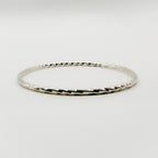 Sterling silver sustainable handmade jewellery bangle on a white background made by Bottlebee small business in Nottingham