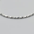 close up of textured silver bangle handmade in Nottingham by Bottlebee