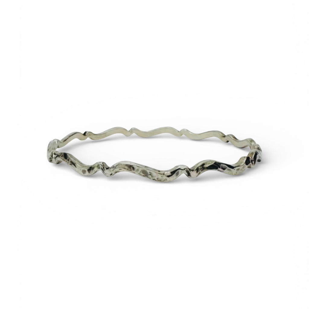 Silver bracelet with wavy design on a white background handmade sustainable bespoke in nottingham by bottlebee