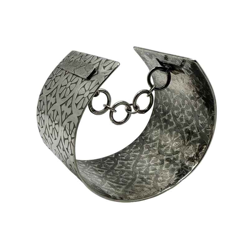 Silver bracelet with chain detail on a white background