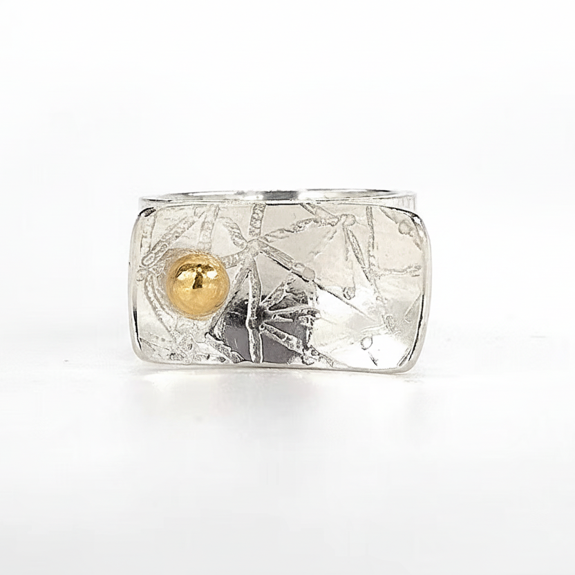 Silver ring with textured design with an 18ct gold ball handmade jewellery in Nottinghan
