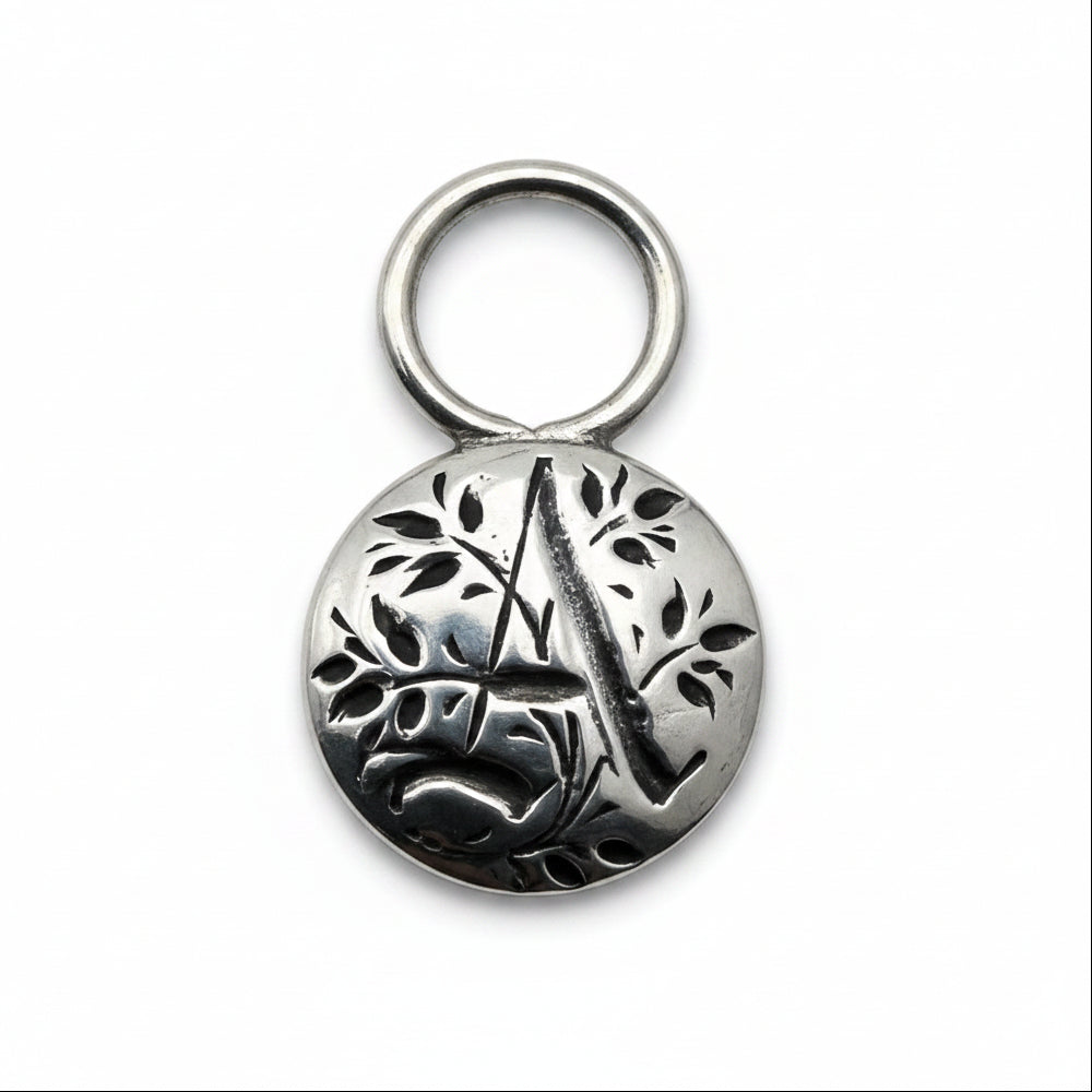 Silver pendant tag with floral gothic initial A for a necklace or keyring on a white background