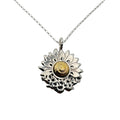 Sterling silver and 18ct gold necklace with a sunflower and butterfly shaped pendant on a white background. The butterflies are merging with the sunflower and the head of the sunflower in the middle of the pendant is made from 18ct gold. Handmade jewellery in Nottingham