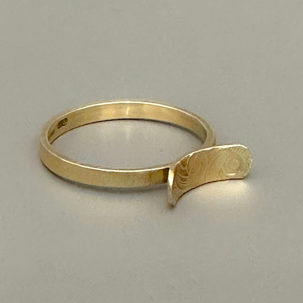 sustainable jewellery 9ct yellow gold ring in 9ct gold engagement ring with a unique design on a grey background