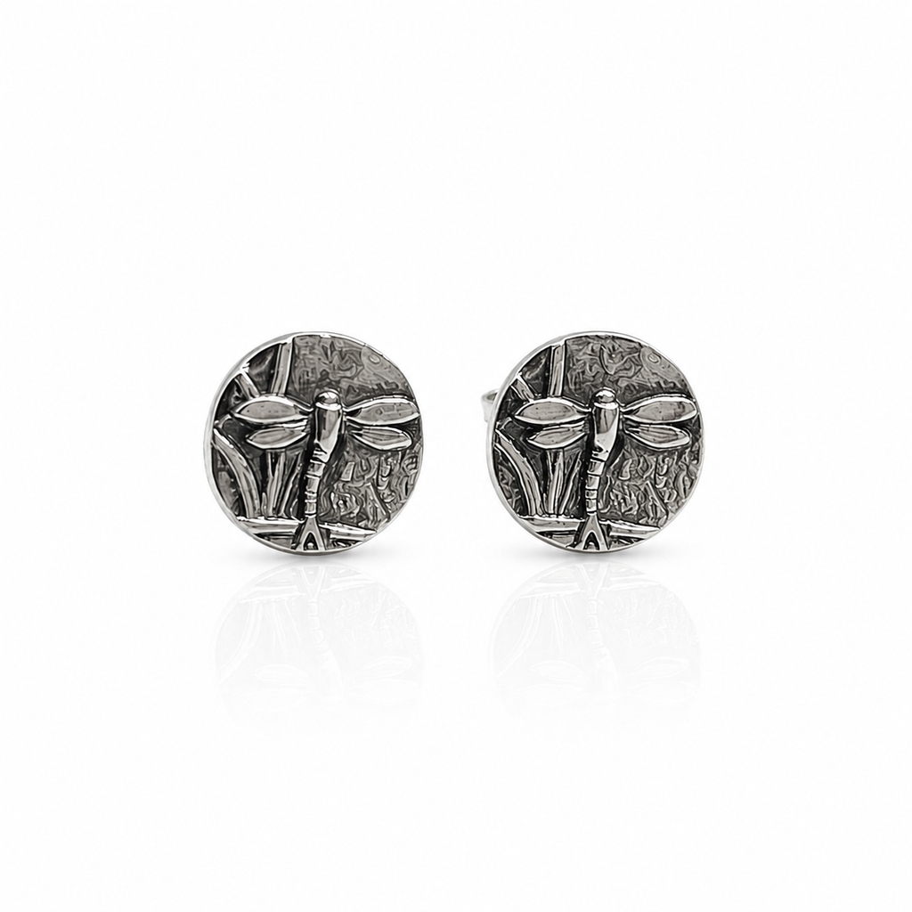 Pair of silver oxidised dragonfly stud earrings on a white background. Jewellery sustainable handmade in Nottingham by small business called Bottlebee