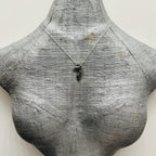 Silver necklace made in Nottingham with recycled silver showing a giraffe pendant on a grey bust