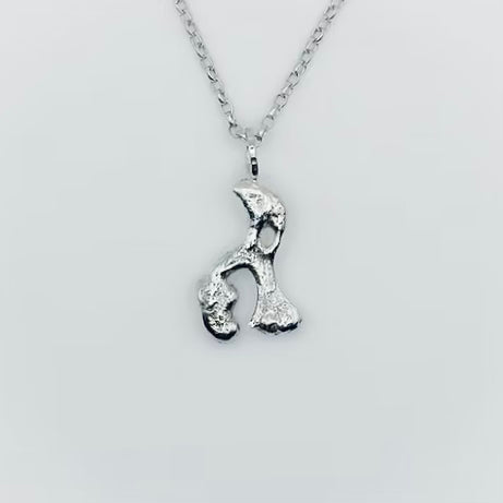 Silver necklace with a unique pendant in the shape of an elephant or hippo on a light grey background sustainable made in Nottingham by Bottlebee
