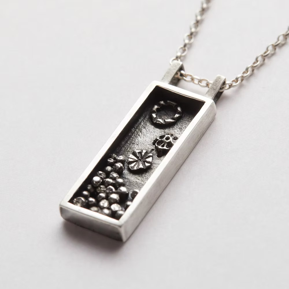 Silver rectangular box pendant necklace with accents which have been oxidised, necklace handmade by Bottlebee in Nottingham who makes sustainable bespoke jewellery