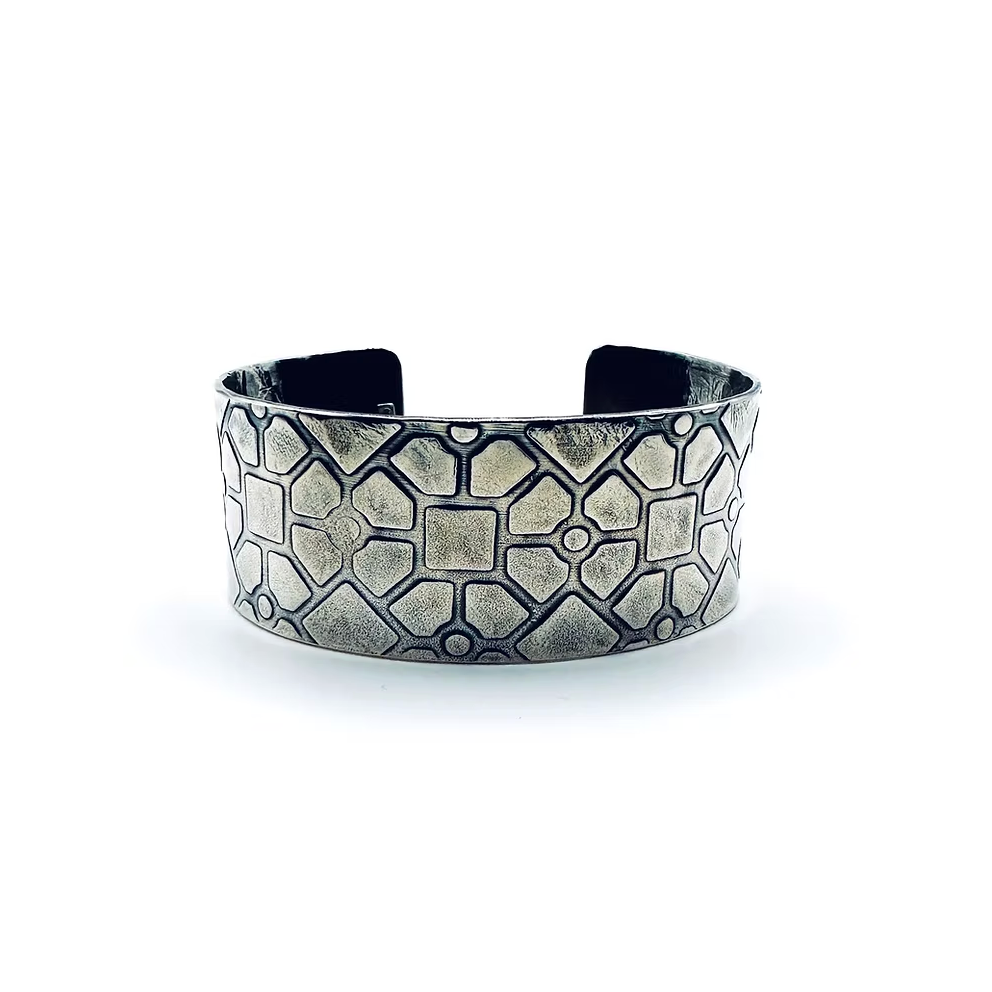 Silver bracelet with geometric pattern on a white background handmade from recycled silver by Bottlebee in Nottingham using sustainable practices