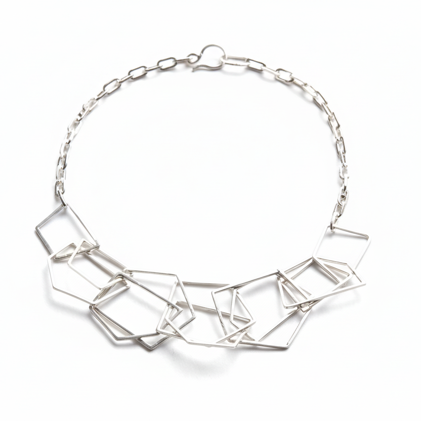 Silver geometric necklace on a white background
