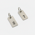 2 keyring tags made from sustainable sterling silver and hand stamped with an S and a T