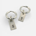 a pair of handmade sterling silver keyrings with hand stamped initials T and S made by a small independant jeweller in Nottingham
