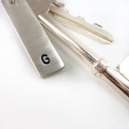 Set of keys with a sterling silver keychain featuring the letter 'G' on a white background suitable for a housewarming gift handmade in Nottingham