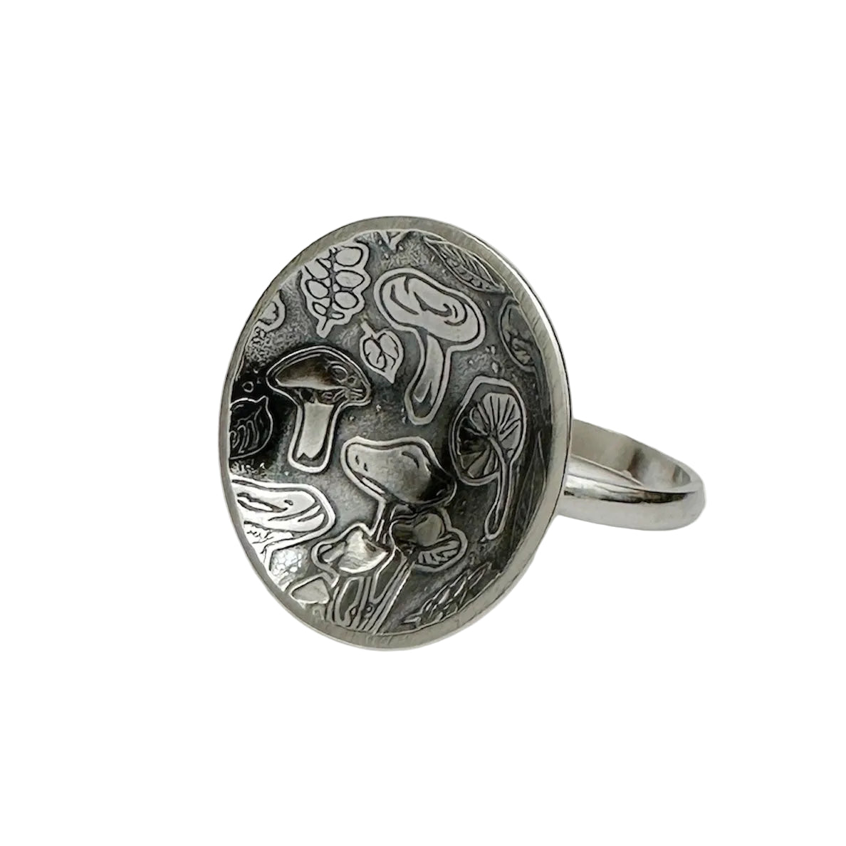handmade sterling silver ring with mushroom pattern on a white background sustainably made by small business Bottlebee in Nottingham