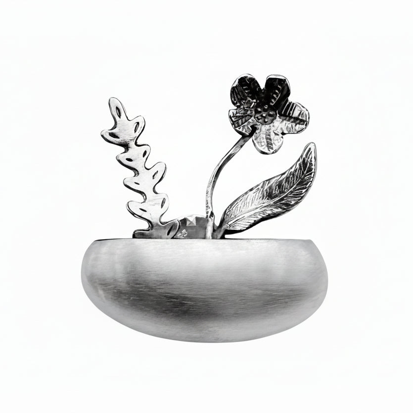 Decorative silver jewellery metal flower pot necklace with floral design on a white background